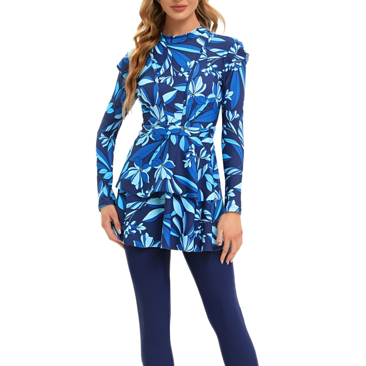 Maillot de bain modeste pour femme avec motif floral bleu et manches longues. Combinaison de bain couvrante avec legging intégré, idéale pour la plage ou la piscine. Style élégant et confortable.