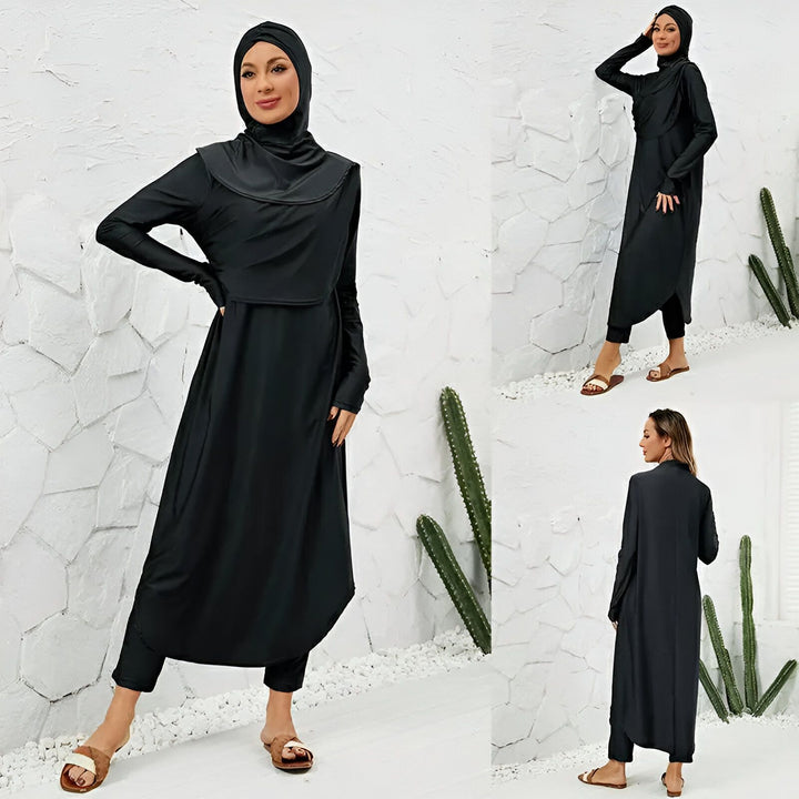Femme portant un burkini noir avec hijab. Vêtement de bain couvrant pour femmes musulmanes, tunique longue, manches longues et legging. Mode pudique, style islamique.