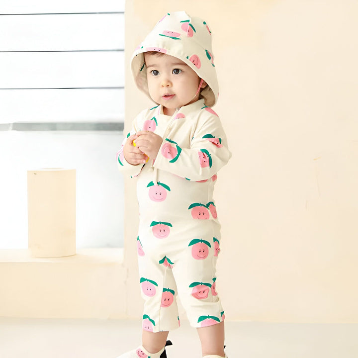 Combinaison de bain turquoise à manches longues pour enfant, motif bananes. Idéal pour la plage ou la piscine. Protection solaire et style fruité.