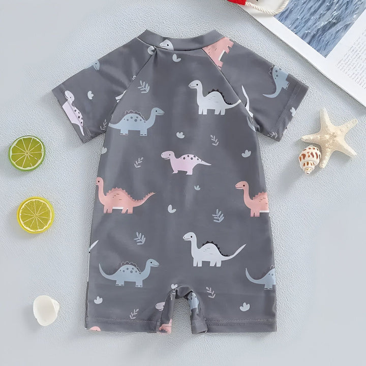 Combinaison de bain pour enfant grise avec fermeture éclair et motifs de dinosaures. Vêtement d'été à manches courtes pour la plage et la piscine.