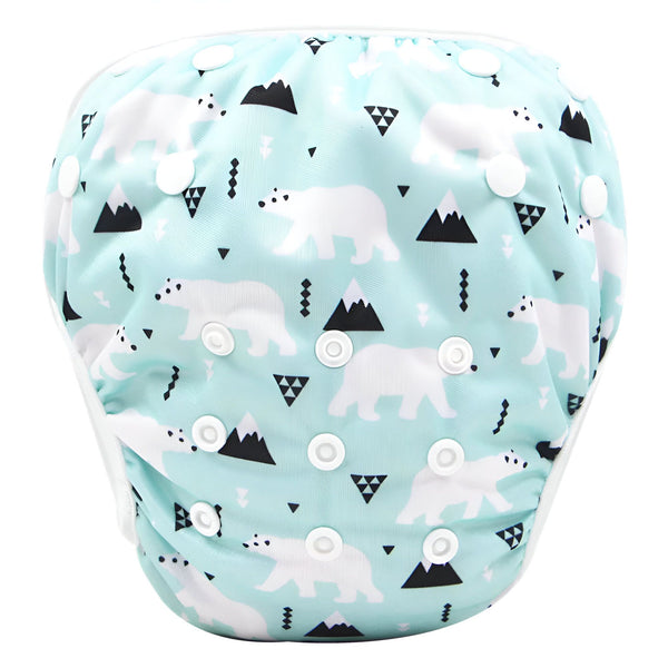 Culotte de bain rose pour bébé, avec des motifs de zèbres, de coeurs et de nœuds. Les bords sont blancs et il y a des boutons-pression blancs sur le côté.