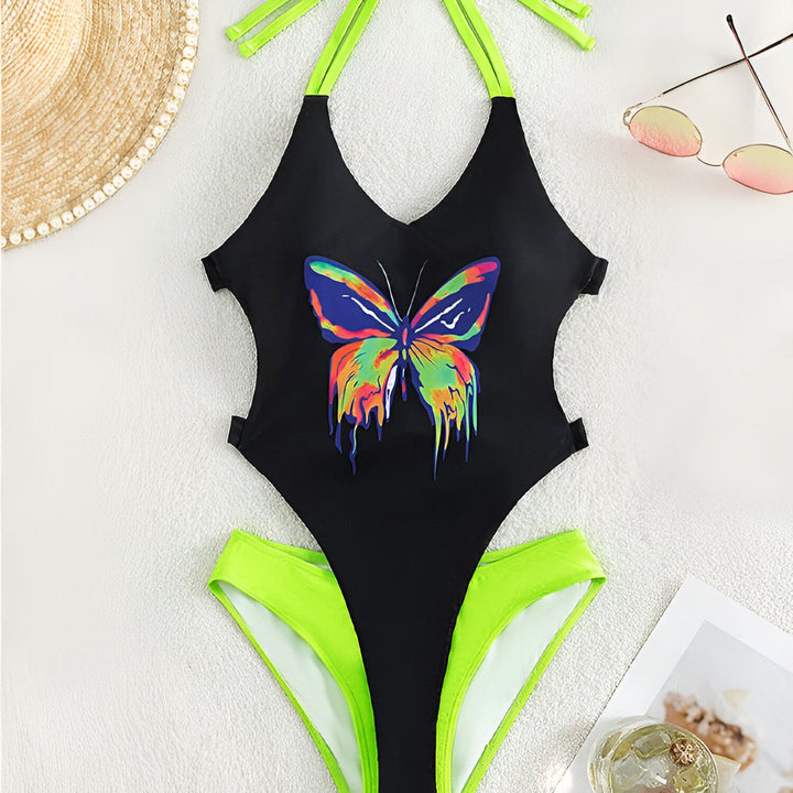 Photo d'un maillot de bain une pièce noir à découpes avec des bretelles vert fluo et un bas de bikini vert fluo assorti. Le maillot a des détails à nœuds.