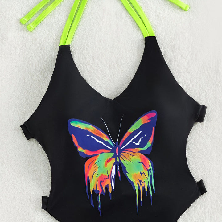 Image d'une femme portant un maillot de bain une pièce noir avec un imprimé papillon coloré et des détails vert fluo. Maillot de bain tendance pour l'été.