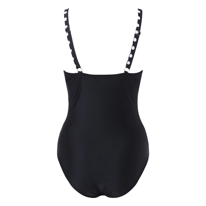 Maillot de bain une pièce noir avec un haut à pois blancs sur une femme, style croisé sur le devant. Élégant et confortable pour la plage ou la piscine.