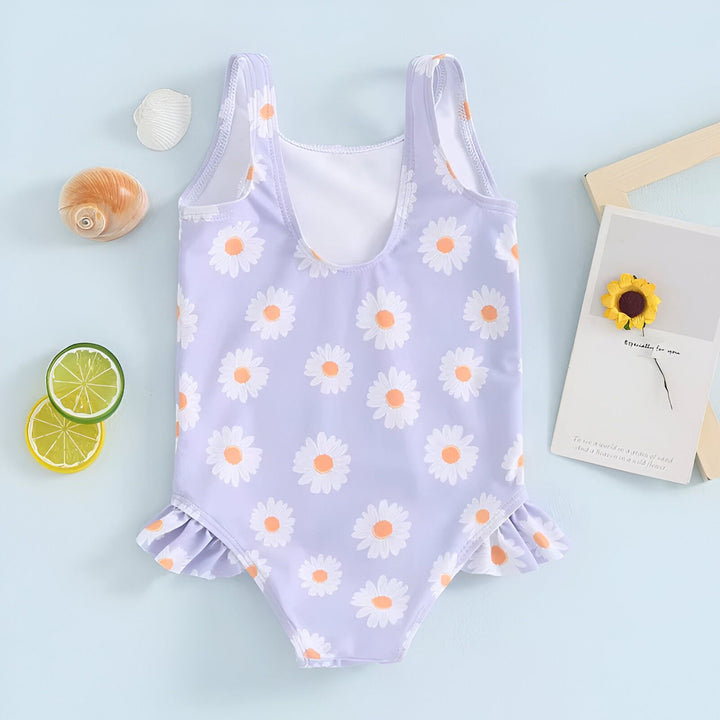 Maillot de bain une pièce pour fille, lilas avec motif marguerites, détails à volants. Vêtement de plage mignon et tendance pour l'été.