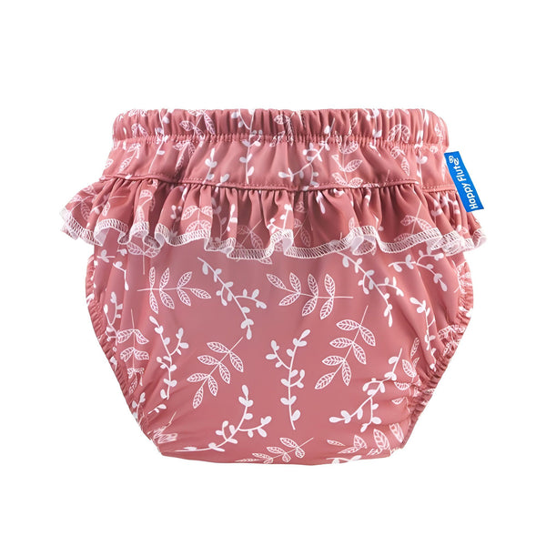 Détail d'un tissu jaune avec motif floral blanc et feuilles grises. Volants froncés en haut.