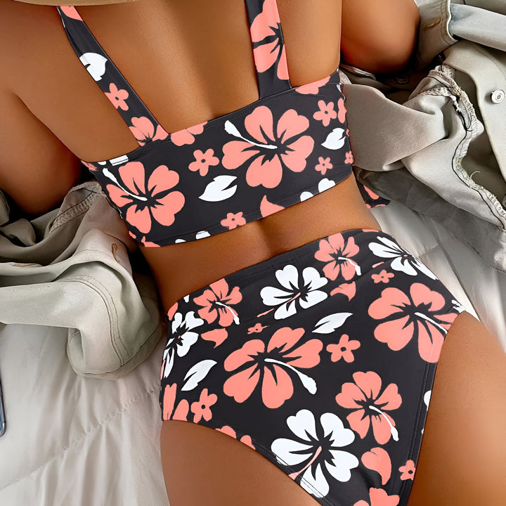Culotte de bikini à motif floral rose, blanc et noir sur fond marbré. Couture noire apparente.