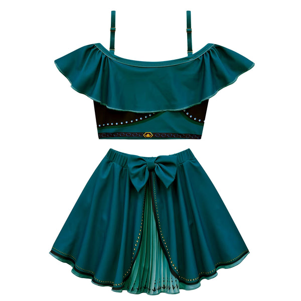 Détail d'un tissu noir et vert émeraude avec des motifs géométriques et des ornements dorés, partie d'un vêtement ou accessoire. Le fond est blanc uni, mettant en valeur les détails du textile.