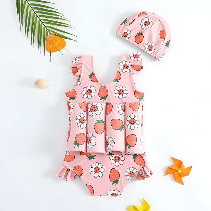 Maillot de bain flottant rose pour bébé avec motif fraises et fleurs souriantes, et bonnet de bain assorti. Idéal pour la piscine ou la plage.