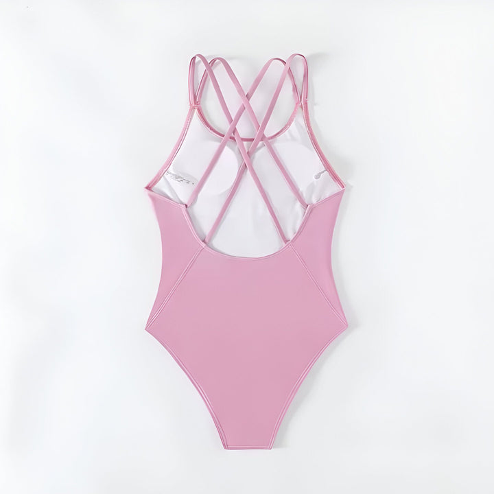 Dos d'un maillot de bain une pièce rose avec des bretelles croisées.