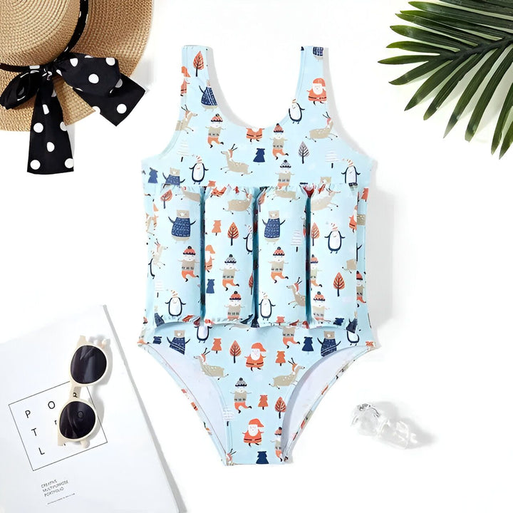 Maillot de bain enfant bleu avec bouées intégrées et motifs d'animaux, chapeau de paille avec ruban à pois, lunettes de soleil et revue sur fond blanc. Idéal pour la plage et la piscine.