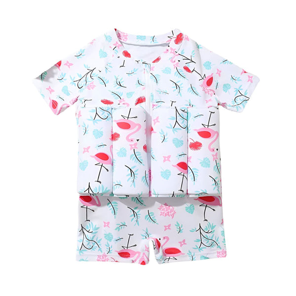 Combinaison de bain pour enfant avec flotteurs intégrés, motif flamants roses et feuillage. Ananas, avocat, coquillages et glaçons en décoration. Idéal pour la plage et les premières baignades en toute sécurité.