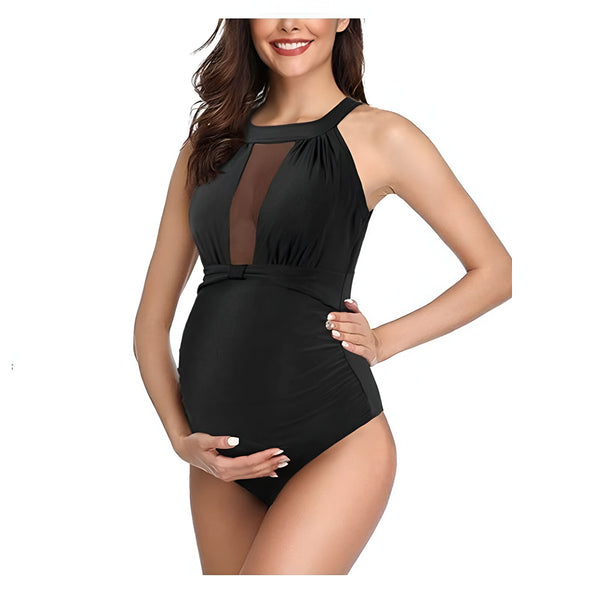 Femme enceinte en maillot de bain noir une pièce avec un dos nu. Vêtement de maternité pour la plage et la piscine. Mode femme enceinte.