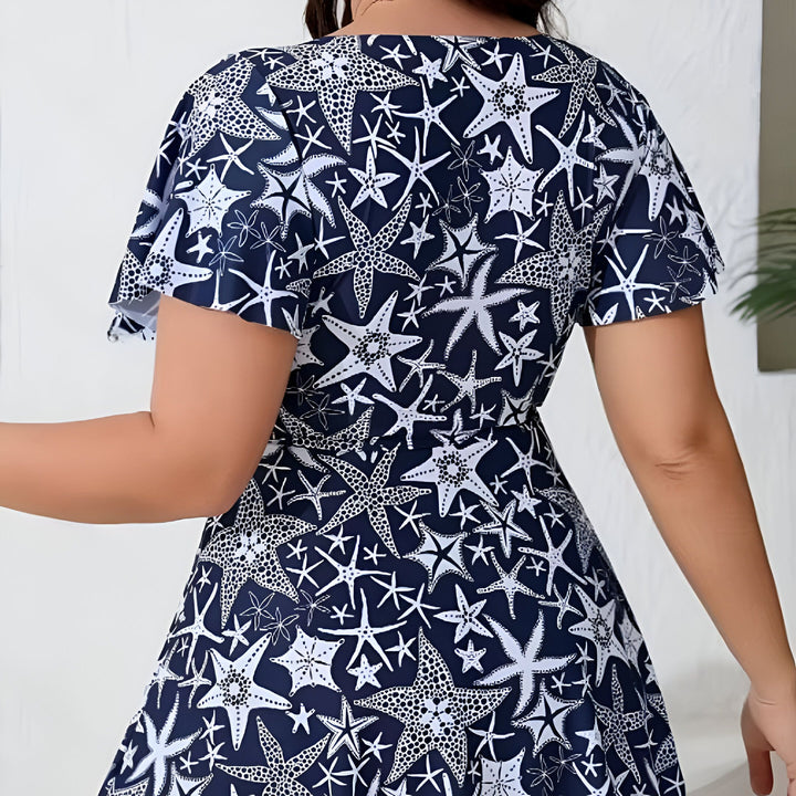 Maillot de bain une pièce bleu marine à motifs étoiles de mer blanches avec un décolleté en V.