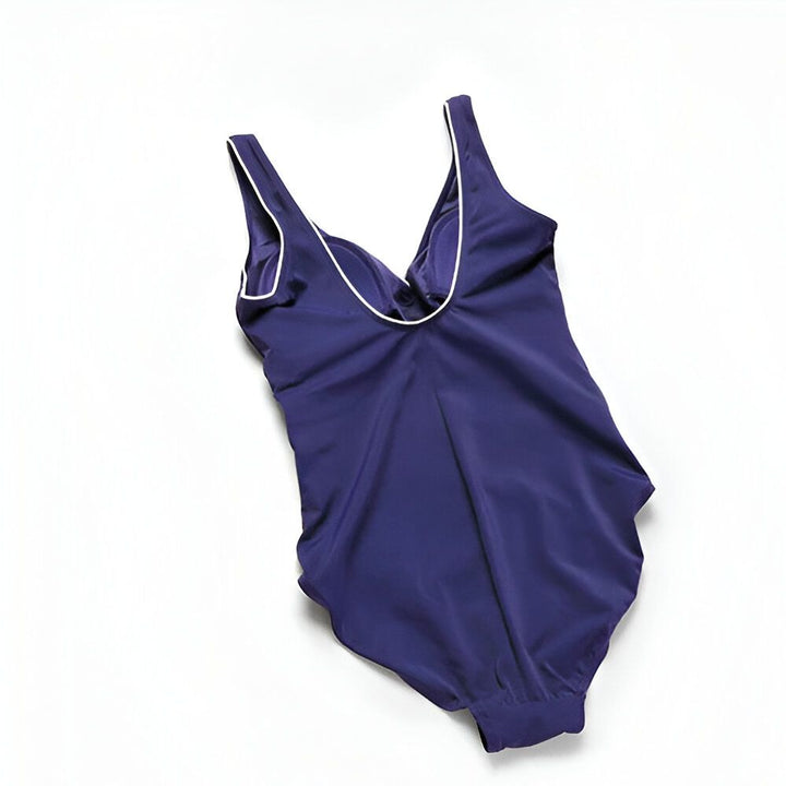 Détail d'un maillot de bain bleu marine avec bonnets intégrés. Gros plan sur la structure de soutien-gorge et les coussinets amovibles. Matière lisse et confortable. Idéal pour la natation ou le bronzage.