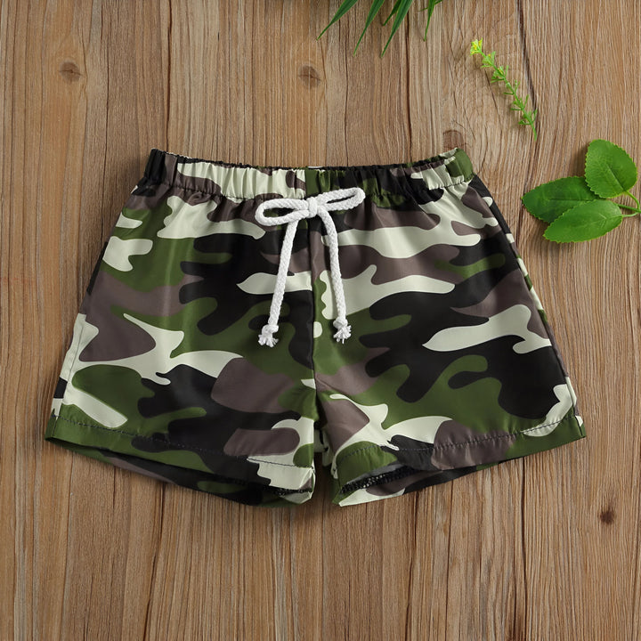 Short de bain pour homme avec un motif de palmiers, cordon de serrage blanc à la taille. Idéal pour la plage et les vacances.