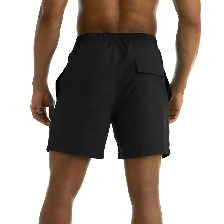 Gros plan sur un tissu vert imperméable, recouvert de gouttes d'eau transparentes de différentes tailles, démontrant ses propriétés hydrofuges. Texture du tissu visible sous les gouttes.