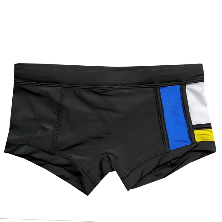Boxer blanc avec motif géométrique bleu, noir et jaune, style Mondrian. Sous-vêtement moderne et coloré pour homme.