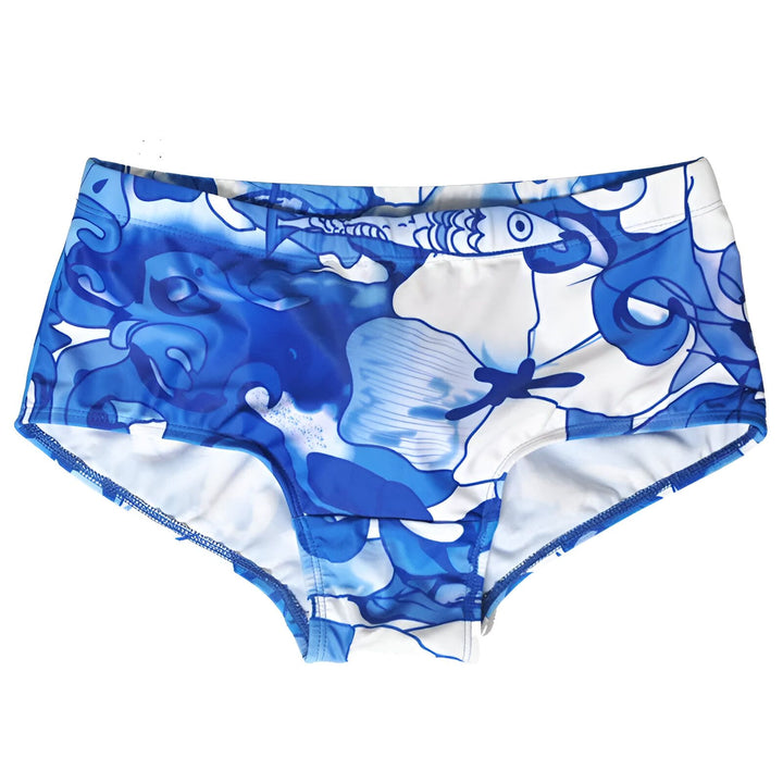 Slip de bain pour homme, imprimé bleu et blanc, avec une protection rembourrée blanche à l'avant. Fermeture par cordon blanc. Idéal pour la plage ou la piscine.